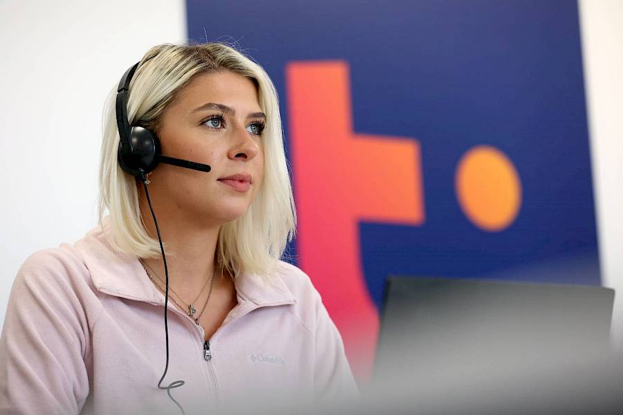 Female contact centre professional wearing headset