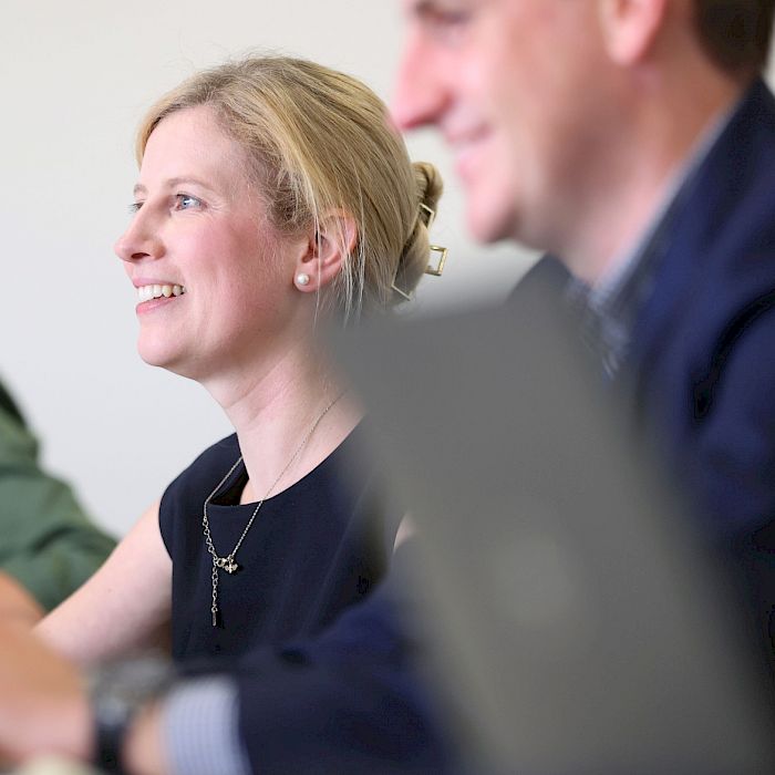 Two colleagues working and smiling