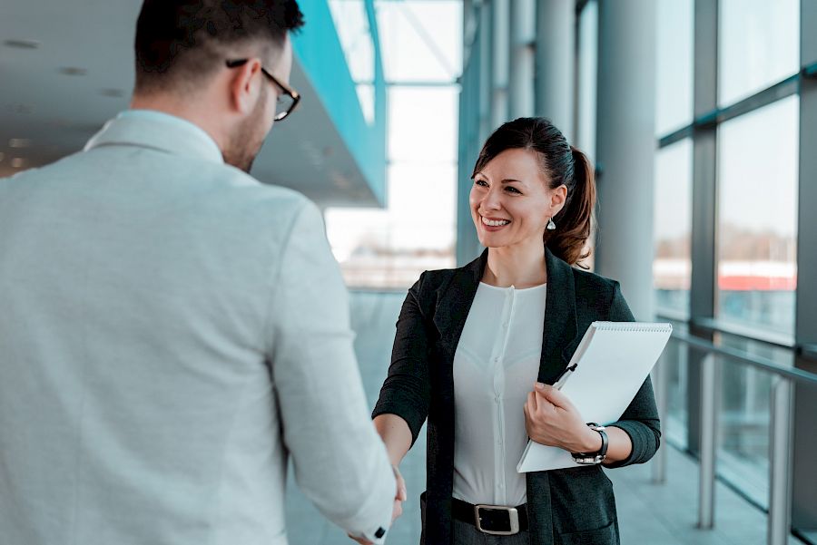 female and male executive shaking hands