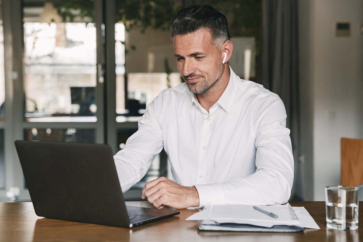 Young male sat in front of laptop concentrating