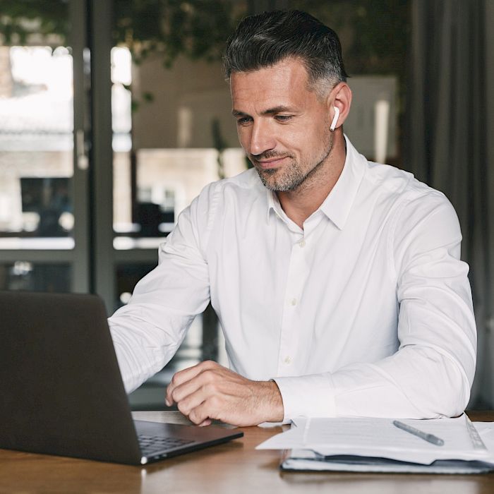 Male on laptop looking at screen intently