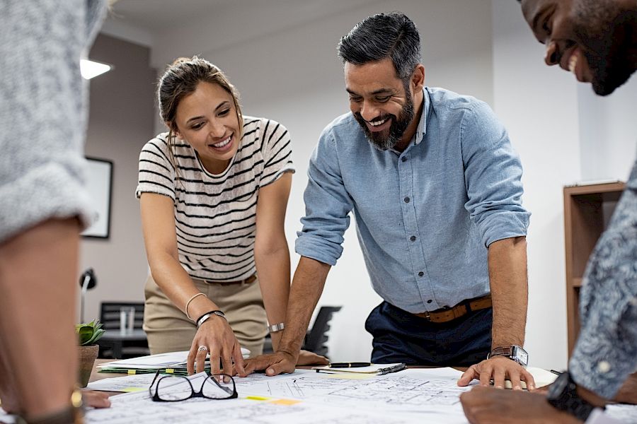 Colleagues looking at plans on a table