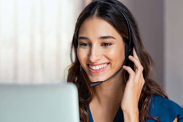 Female professional with headset at a computer