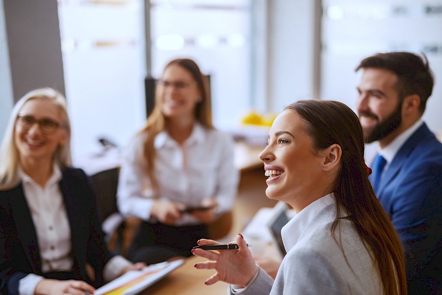 Team of executives smiling in a meeting