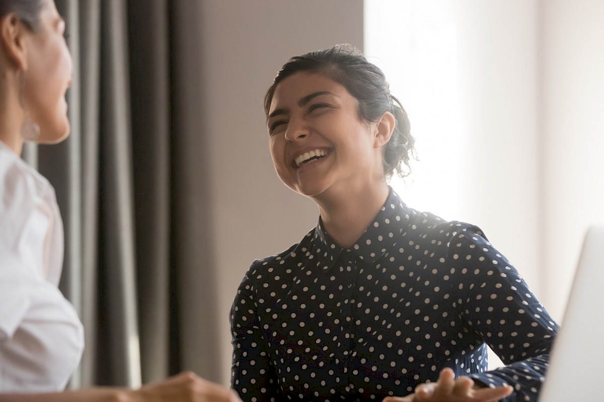 Happy woman laughing with colleague