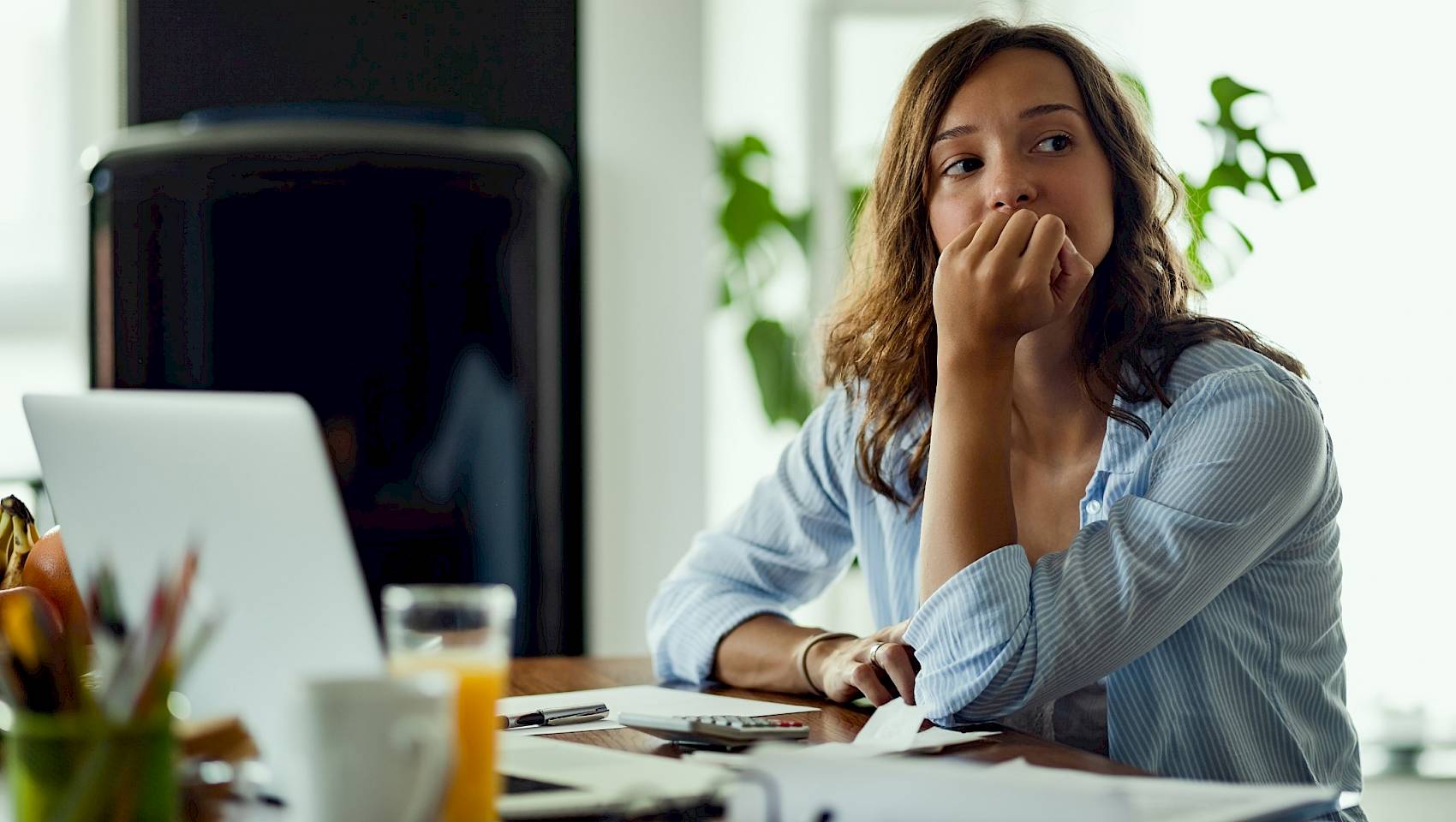 Young female looking stressed in front of pc