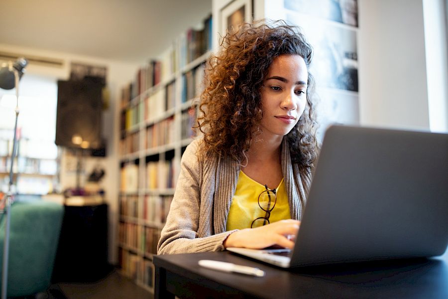 Woman on laptop looking pensive