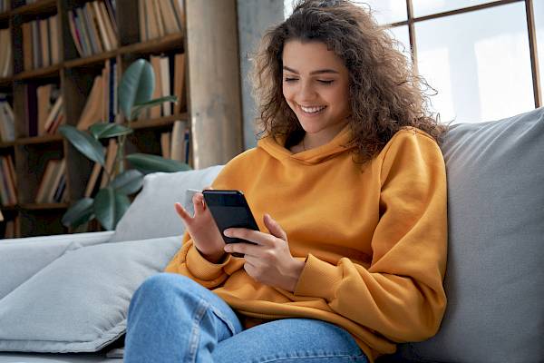 young woman smiling on mobile phone