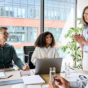 Diverse work team in meeting smiling