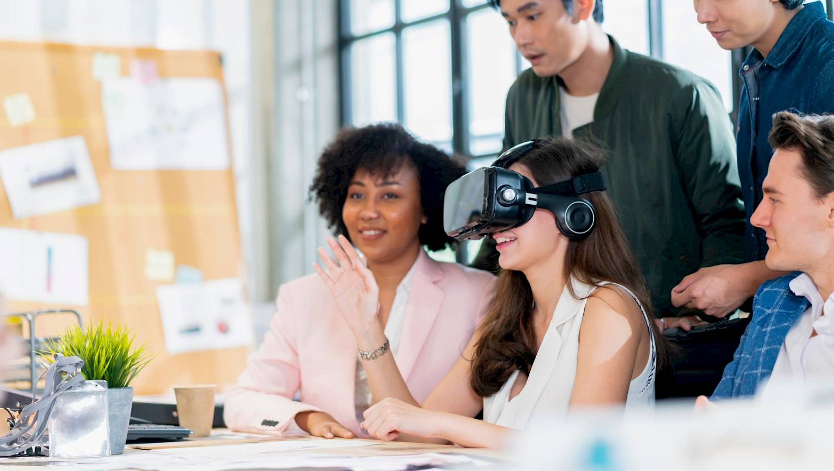 Team discussion with a lady wearing a VR headset