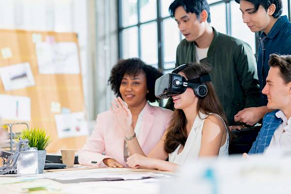 Team discussion with a lady wearing a VR headset