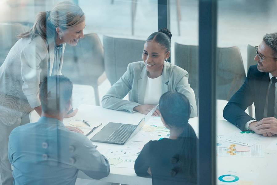 professional team in meeting in glass walled office