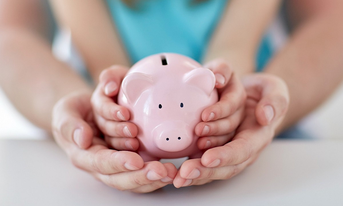 Hands holding a piggy bank