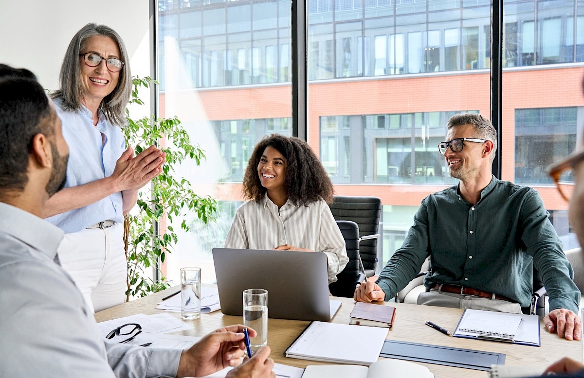 Executives in a team meeting with lady presenting