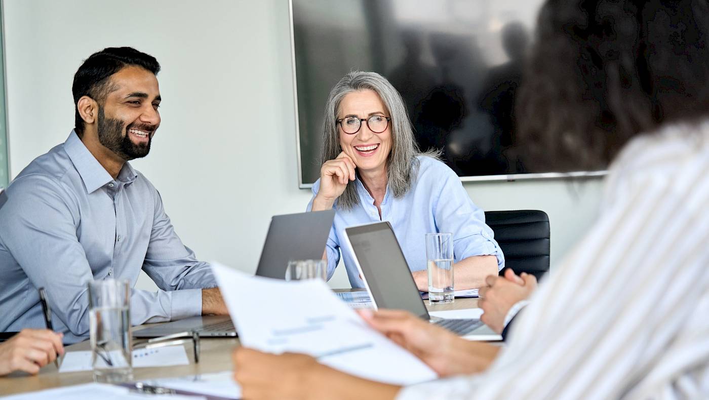 3 colleagues having a discussion at the table with notes