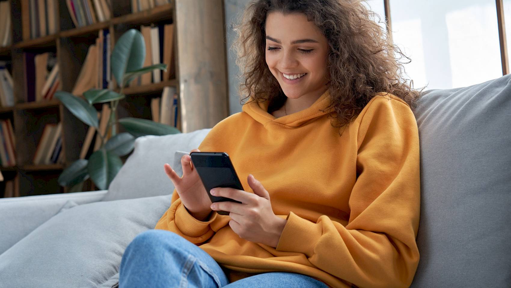 Young women looking at phone and smiling