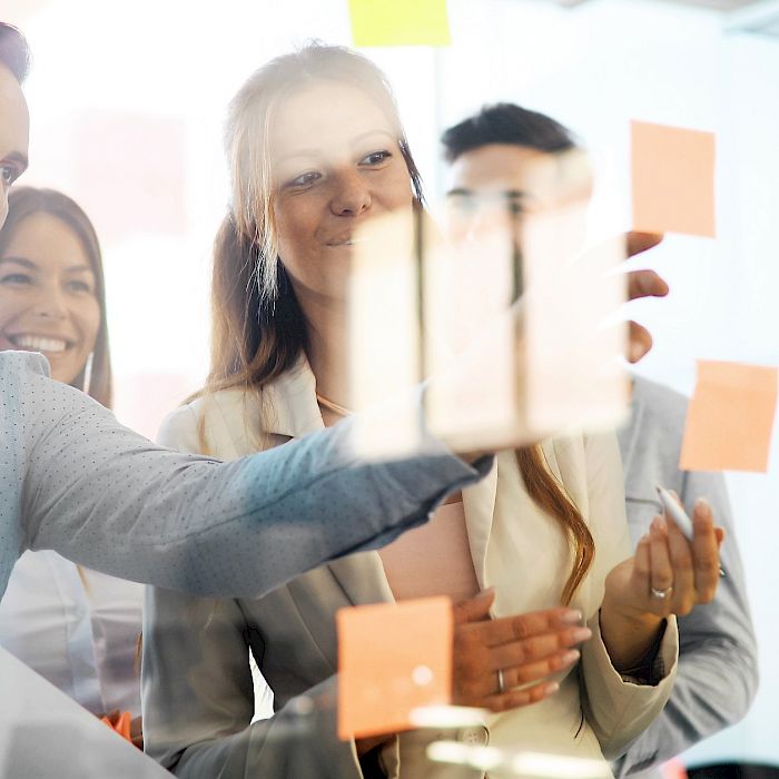 Project team planning with sticky notes at a team whiteboard