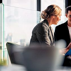 male and female in office meeting