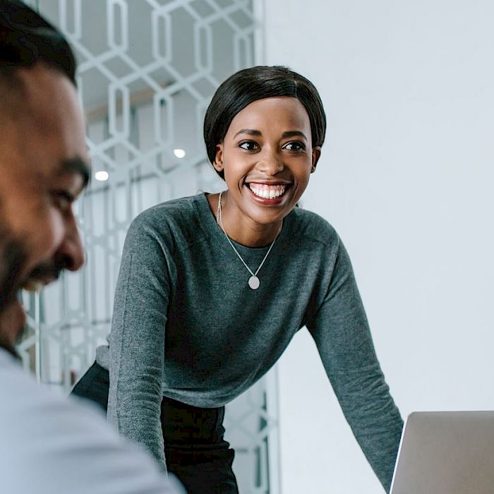 Female colleague standing and smiling