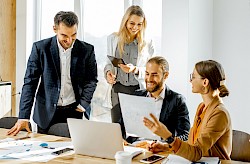 Team of colleagues viewing  a laptop