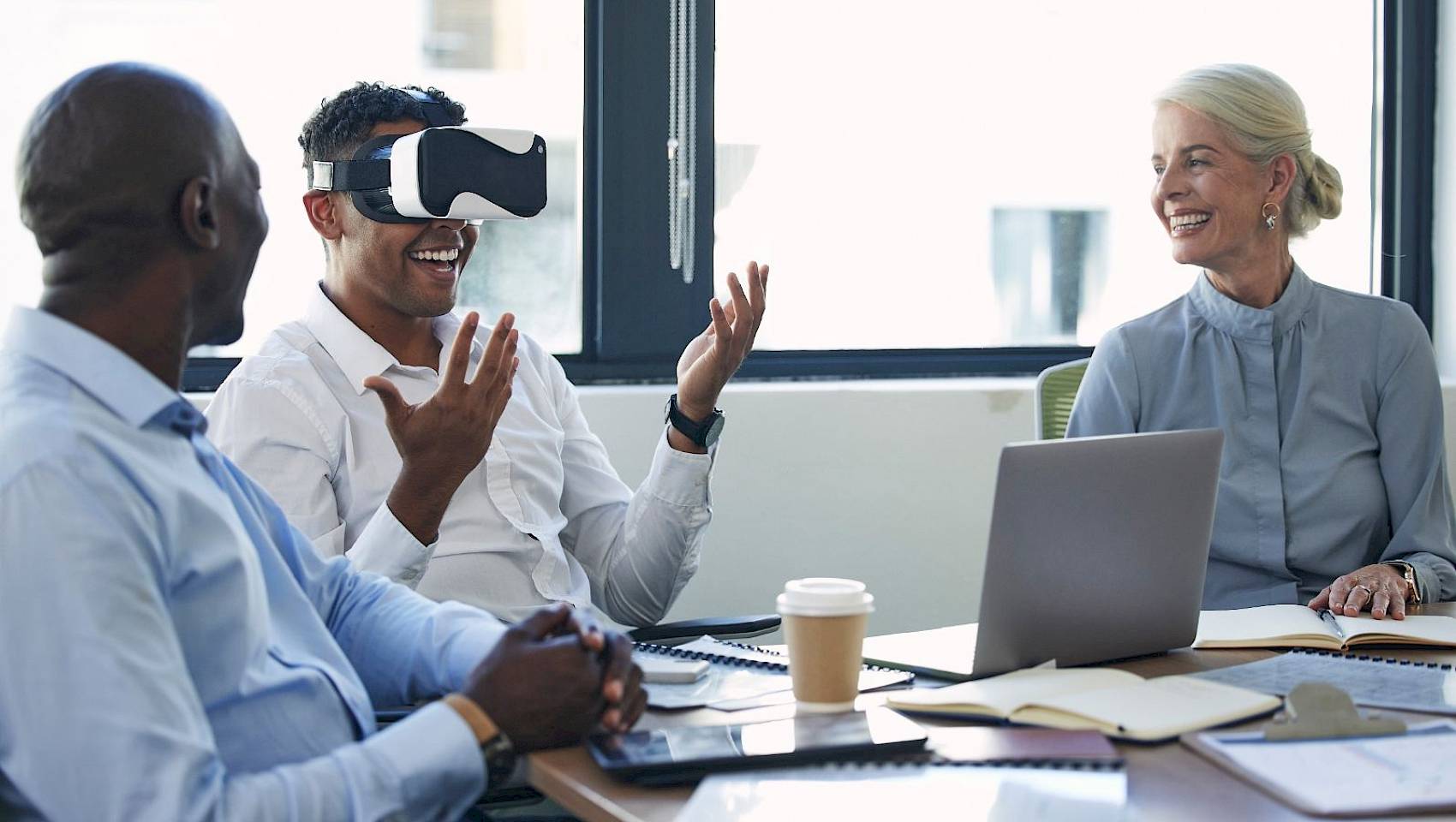 Team discussion with a man wearing a VR headset