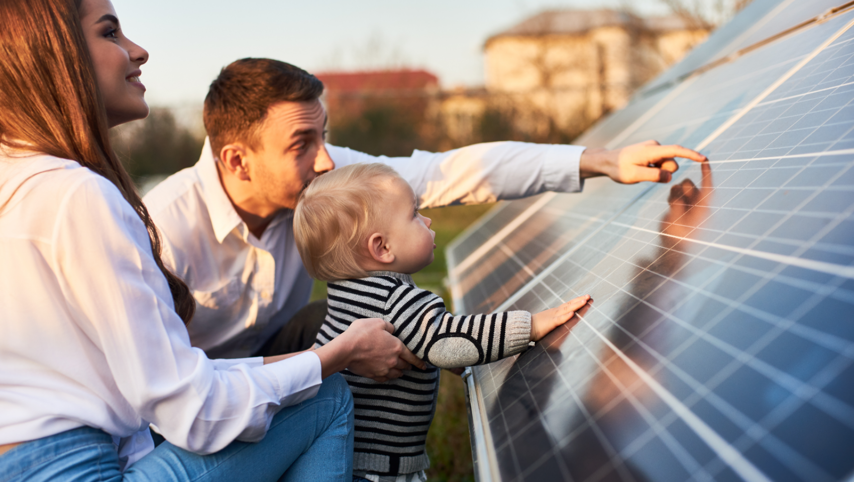 Family with young child leaning on solar panel